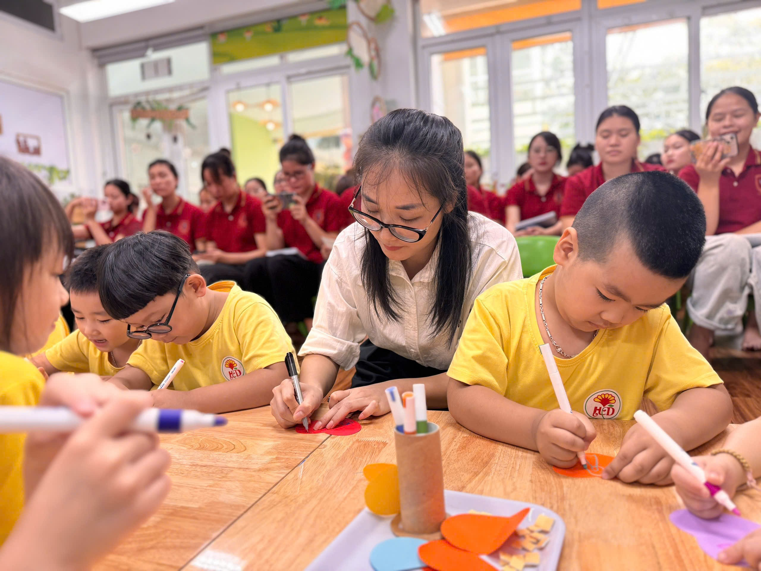 A group of children coloring on paper
AI-generated content may be incorrect.