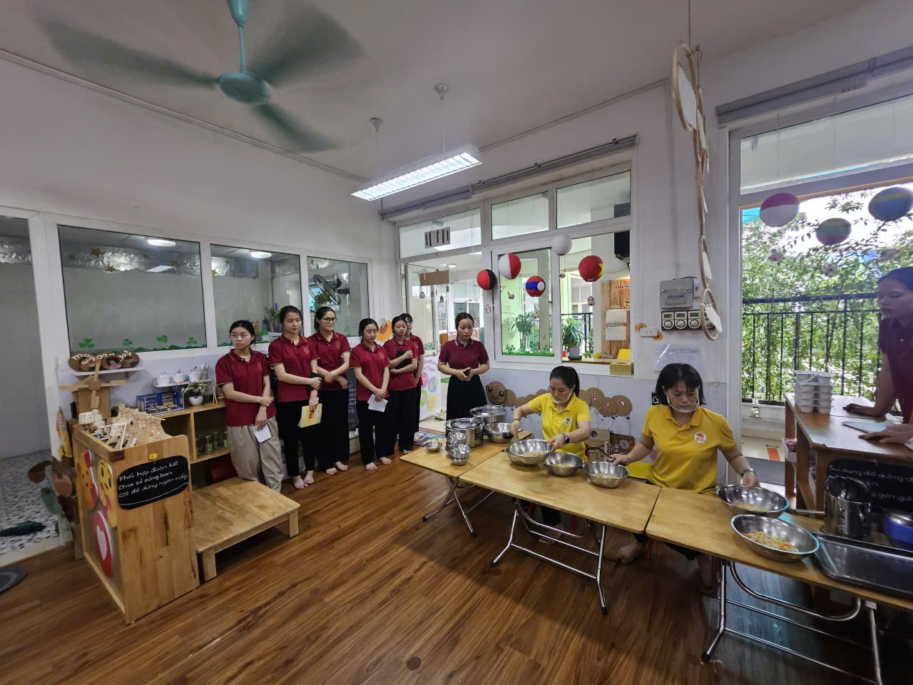 A group of people standing around a table
AI-generated content may be incorrect.