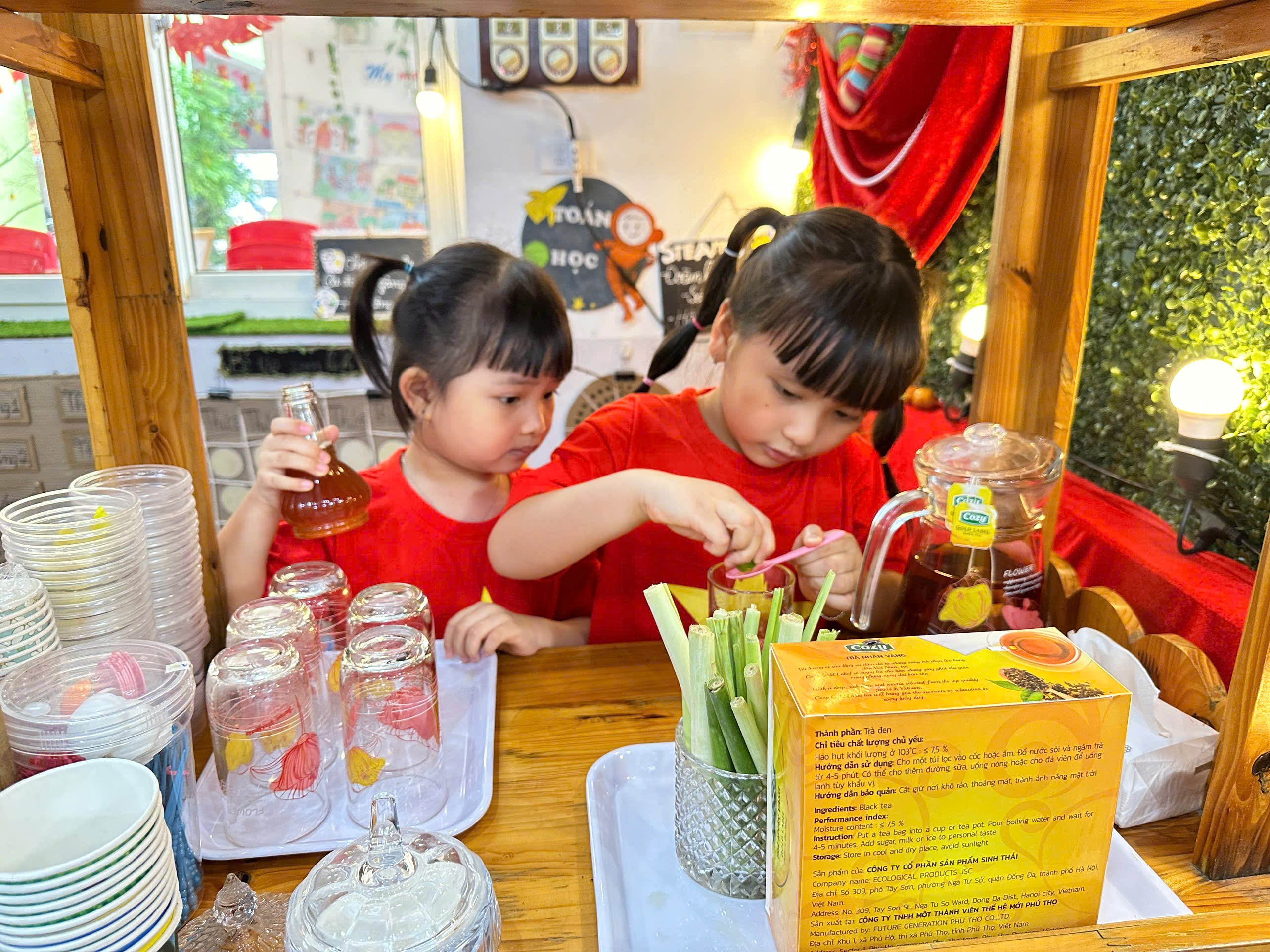 Two girls pouring juice into a glass jar
AI-generated content may be incorrect.