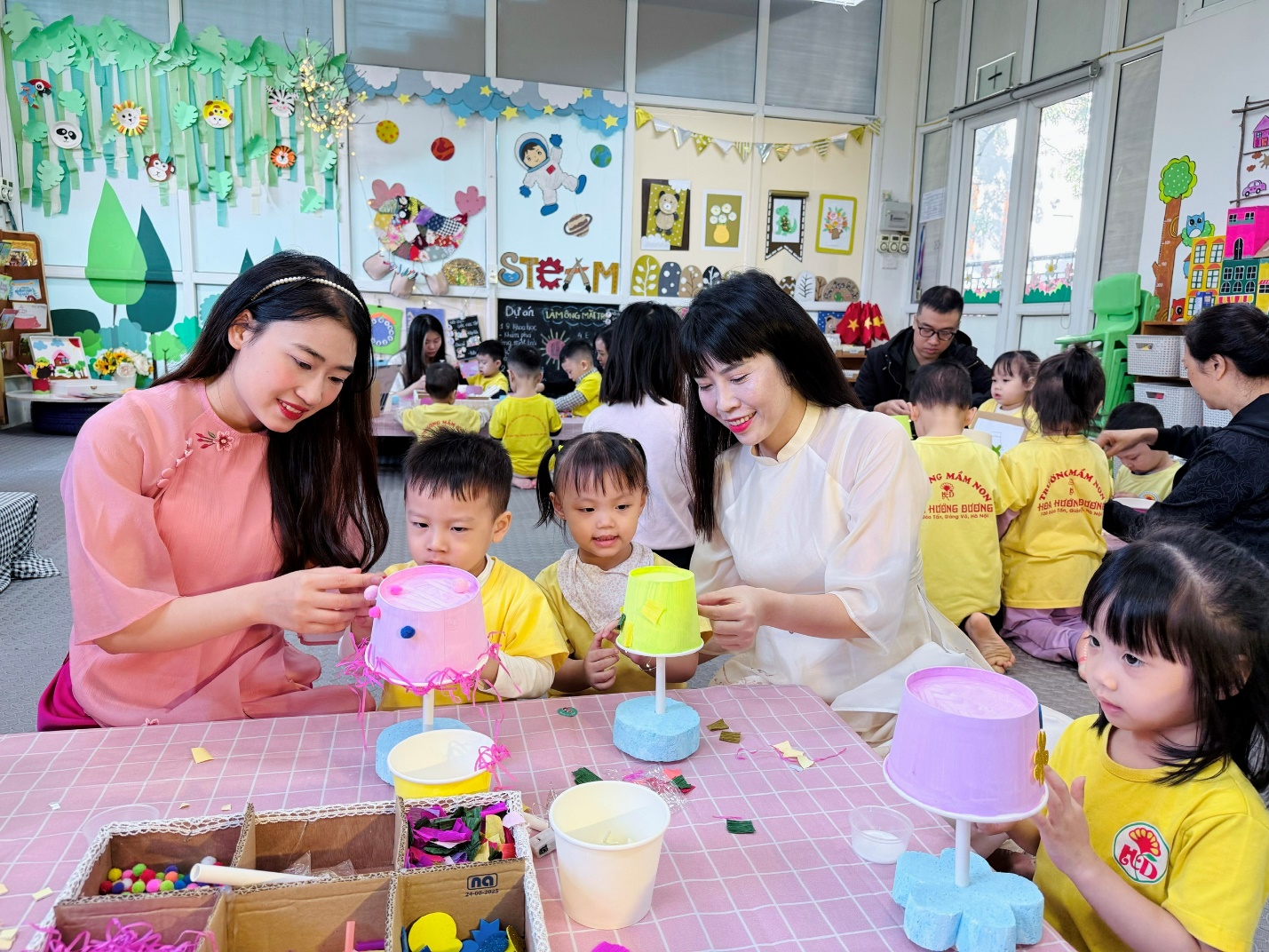 A group of people sitting at a table with a cake

AI-generated content may be incorrect.