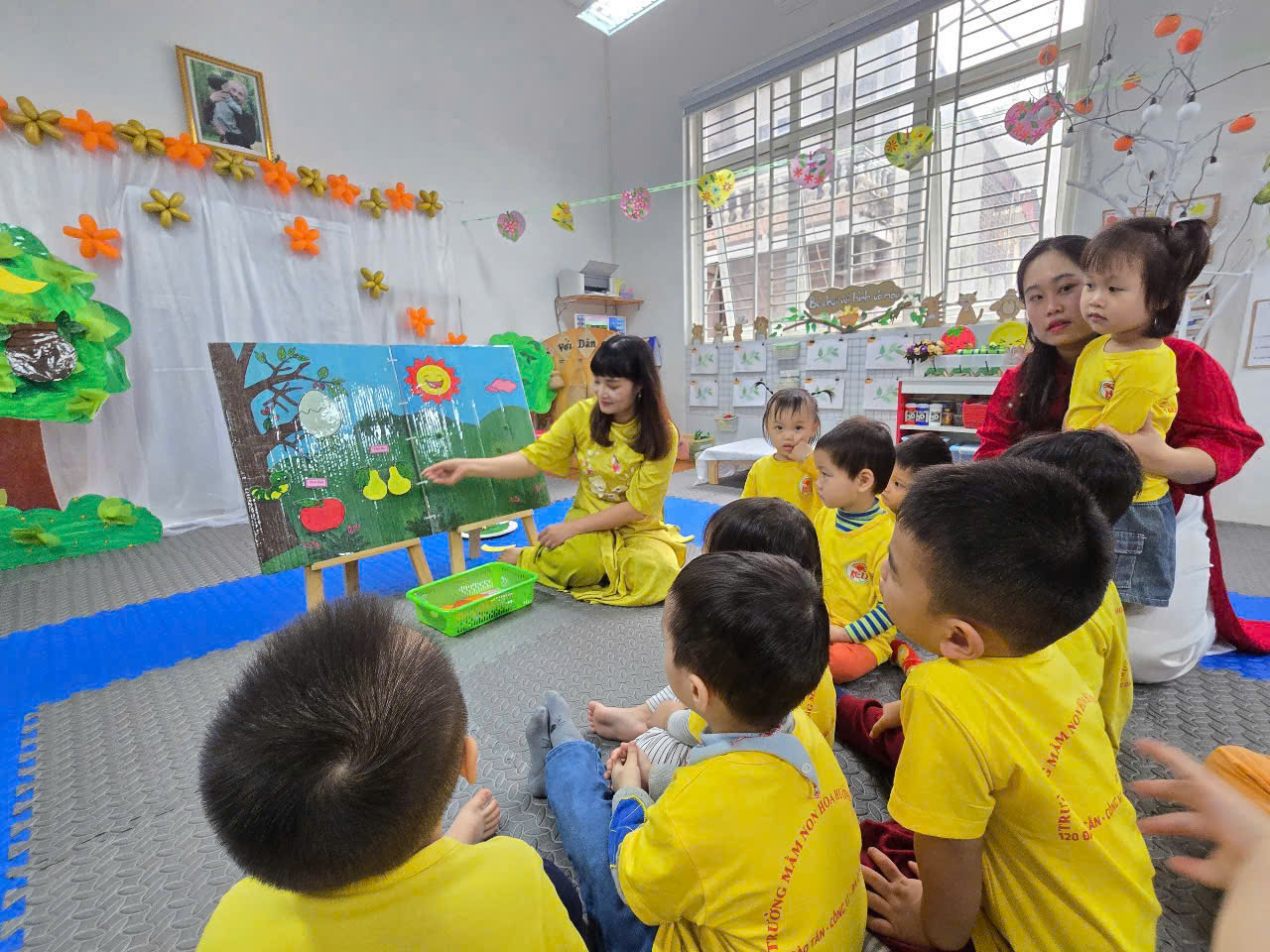 A group of children sitting on the floor in a room
AI-generated content may be incorrect.